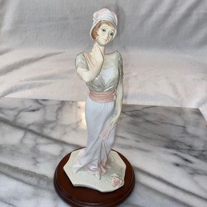 Figurine of a woman wearing a feather hat